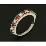 An 18 ct white gold diamond and ruby half hoop ring, size Q/R (see illustration).