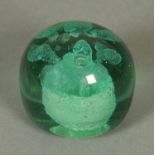 A 19th century glass dump doorstop or paperweight. Diameter approximately 8.5 cm.