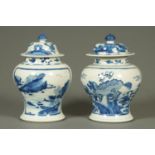 A near pair of 19th century blue and white jars and covers,