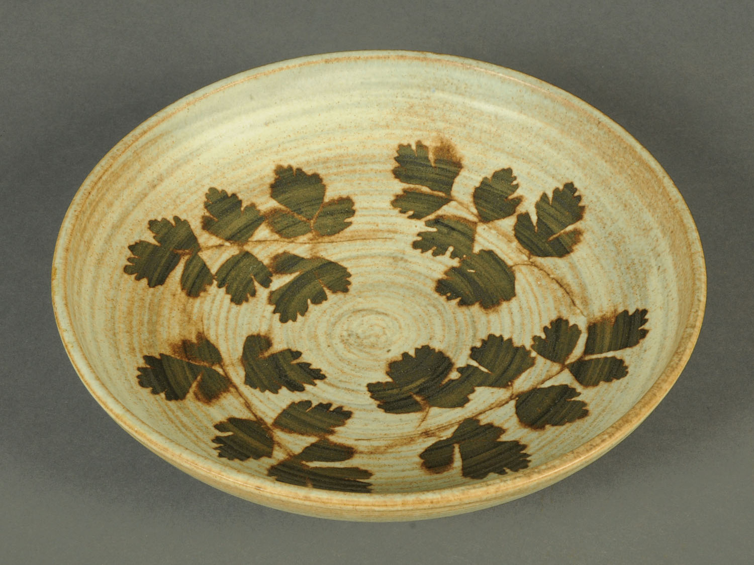 A Furness Pottery bowl, decorated with leaves. Diameter 25 cm.