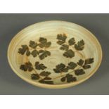 A Furness Pottery bowl, decorated with leaves. Diameter 25 cm.