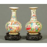 A pair of Chinese Famille Rose vases, each with hardwood stand.