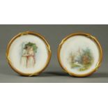 A pair of handpainted porcelain plaques, circular, each in gilt frame and glazed,