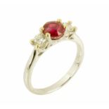 An 18 ct gold round ruby and round brilliant cut diamond three stone ring, ruby weight +/- .