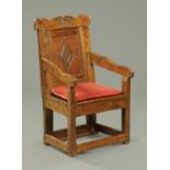 A Queen Anne period oak Wainscot chair, carved and dated "1704" to the top rail,