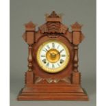 An Edwardian walnut cased Ansonia mantle clock, with two-train spring driven movement.