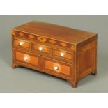 A George III mahogany miniature chest of drawers,