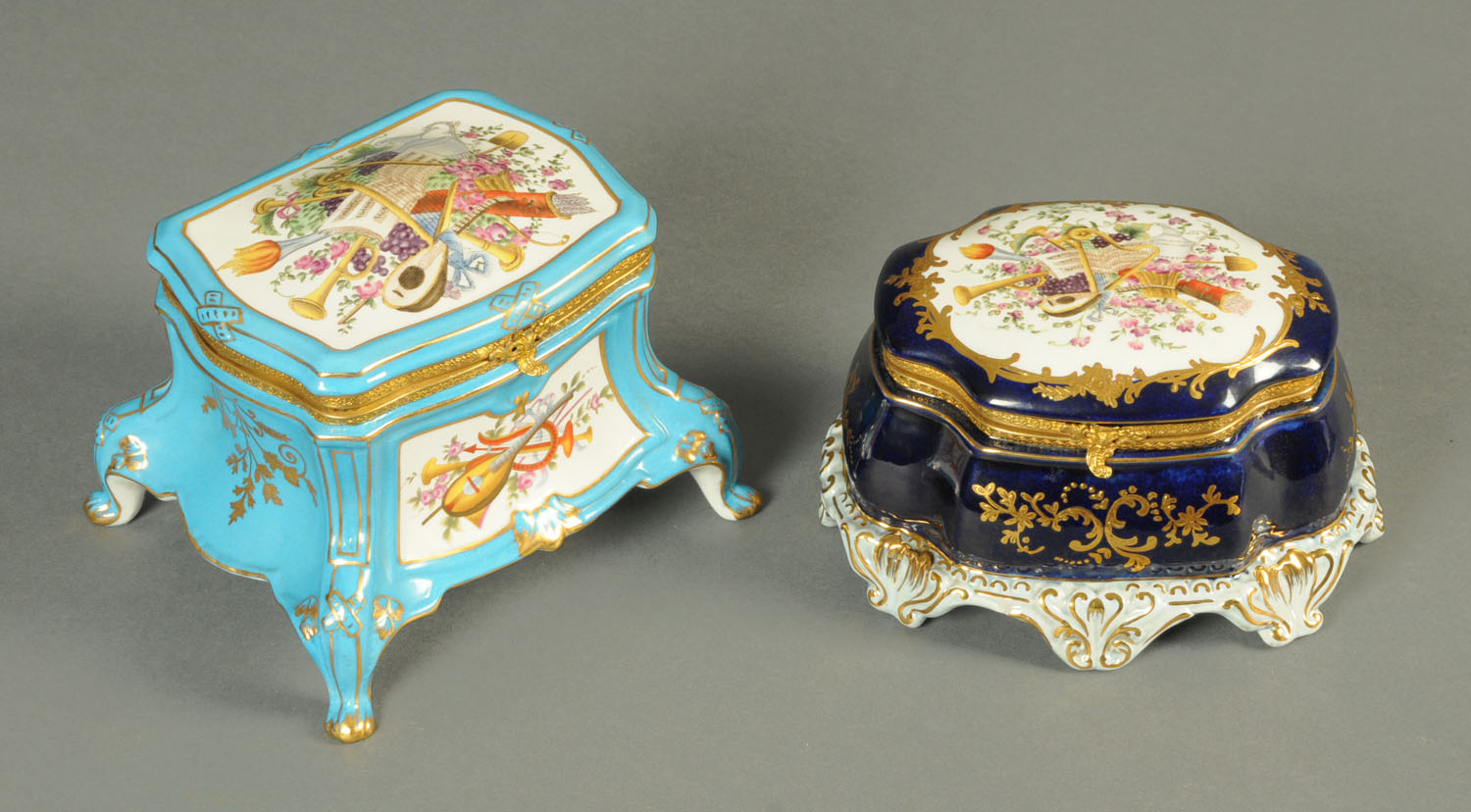 A Sevres style porcelain casket, royal blue, decorated to the lid with musical motifs, length 18 cm,