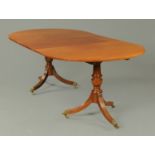 A late 19th/early 20th century mahogany twin pillar dining table,