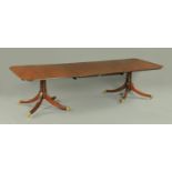 A George III style mahogany twin pillar dining table,