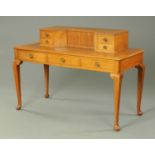 An Art Deco walnut desk, the superstructure fitted with a cupboard and drawers,