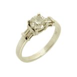 An 18 ct white gold solitaire diamond ring, with diamond to centre and baguettes to each shoulder,