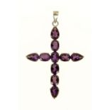 A large gold crucifix, set with ten teardrop and oval cut amethysts.