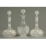 A pair of hob cut wine decanters, and a similar port decanter. Tallest 30 cm.