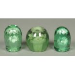 Three 19th century green glass doorstops. Largest height 11 cm (see illustration).