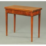 A George III mahogany turnover top tea table, raised on square tapered legs. Width 87 cm.