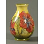 A Moorcroft vase, with yellow and green ground, green script initials and paper label "W.