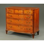 An early 19th century satinwood serpentine fronted chest of drawers,