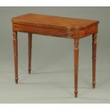 A George III mahogany ebony strung turnover top card table, raised on turned tapered legs.