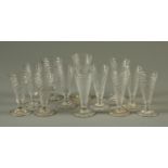 A matched set of twelve mid 18th century wrythen moulded miniature tumblers,