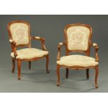 A pair of French walnut open armchairs,