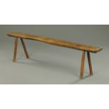 A late 17th/early 18th century oak bench, raised on four angled legs.