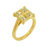 An 18 ct yellow gold four stone princess cut light yellow diamond ring, diamond weight +/- 2.