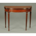 A Regency mahogany turnover top card table, ebony strung and raised on turned tapered reeded legs.