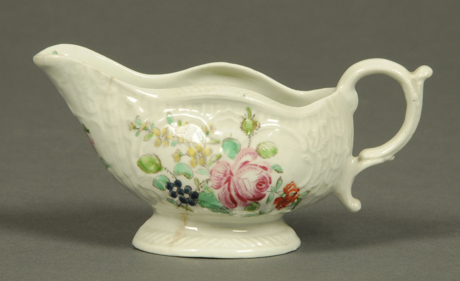 A Worcester silver shaped sauce boat, polychrome, decorated with flowers, circa 1760, length 13.