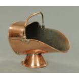 A 19th century copper coal helmet, with loop handle and socle base.