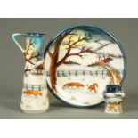 Three pieces of Moorcroft, foxes in Winter landscape and comprising 26.5 cm plate, 24 cm vase and 8.