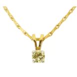 An 18 ct two tone gold pendant on chain, set with a diamond weighing +/- .30 carats.