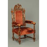 A Victorian carved oak throne type armchair, with bird of prey cresting rail, upholstered back,