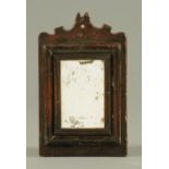 A small antique wooden framed mirror. Overall height 31 cm, width 19 cm.