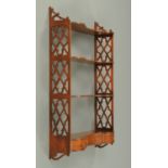 An Edwardian mahogany wall mounting shelf unit,