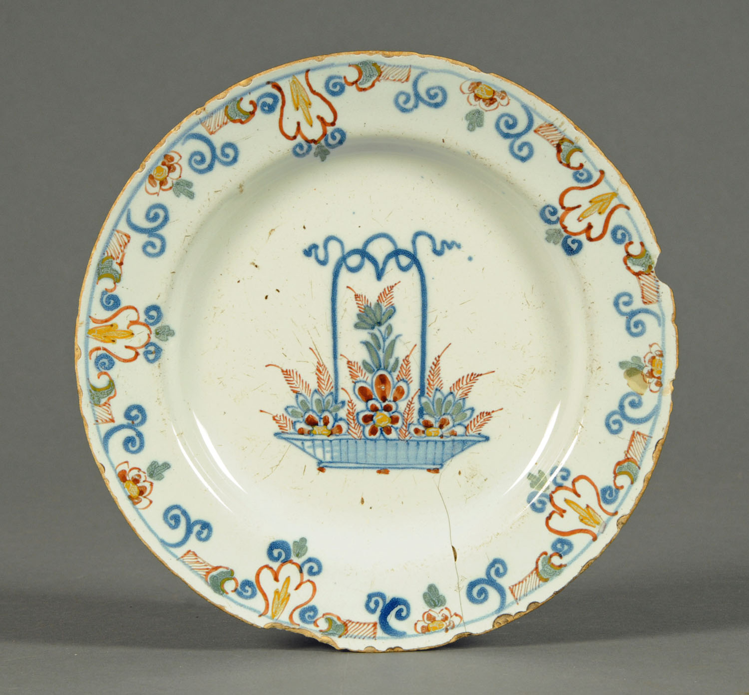 Three 18th century Delft tin glazed plates, polychrome and two underglaze blue.