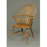 A 19th century ash Windsor armchair, with pierced splat back, solid seat and turned legs.