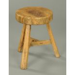 A 19th century burr elm circular table or stool, with three splayed legs united by stretchers.