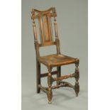 An antique oak hall chair, with solid seat and raised on turned legs.