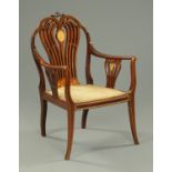 A late Victorian mahogany satinwood and ivory inlaid elbow chair, raised on splayed front legs.