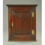 A George III oak hanging cupboard,