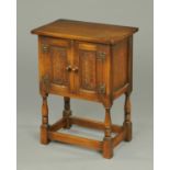 A reproduction oak side cabinet,