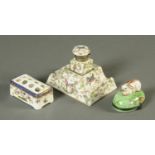 A 19th century porcelain inkwell on stepped stand, a Continental pen stand and a trinket box.