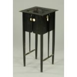 A William Morris style black painted plant stand, raised on tapered legs of square section.