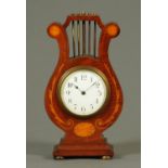 An Edwardian inlaid mahogany lyre shaped clock, with single-train movement. Height 26.