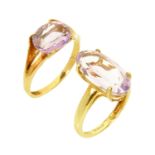 A gold oval cut amethyst fluted ring, and a gold and amethyst ring.