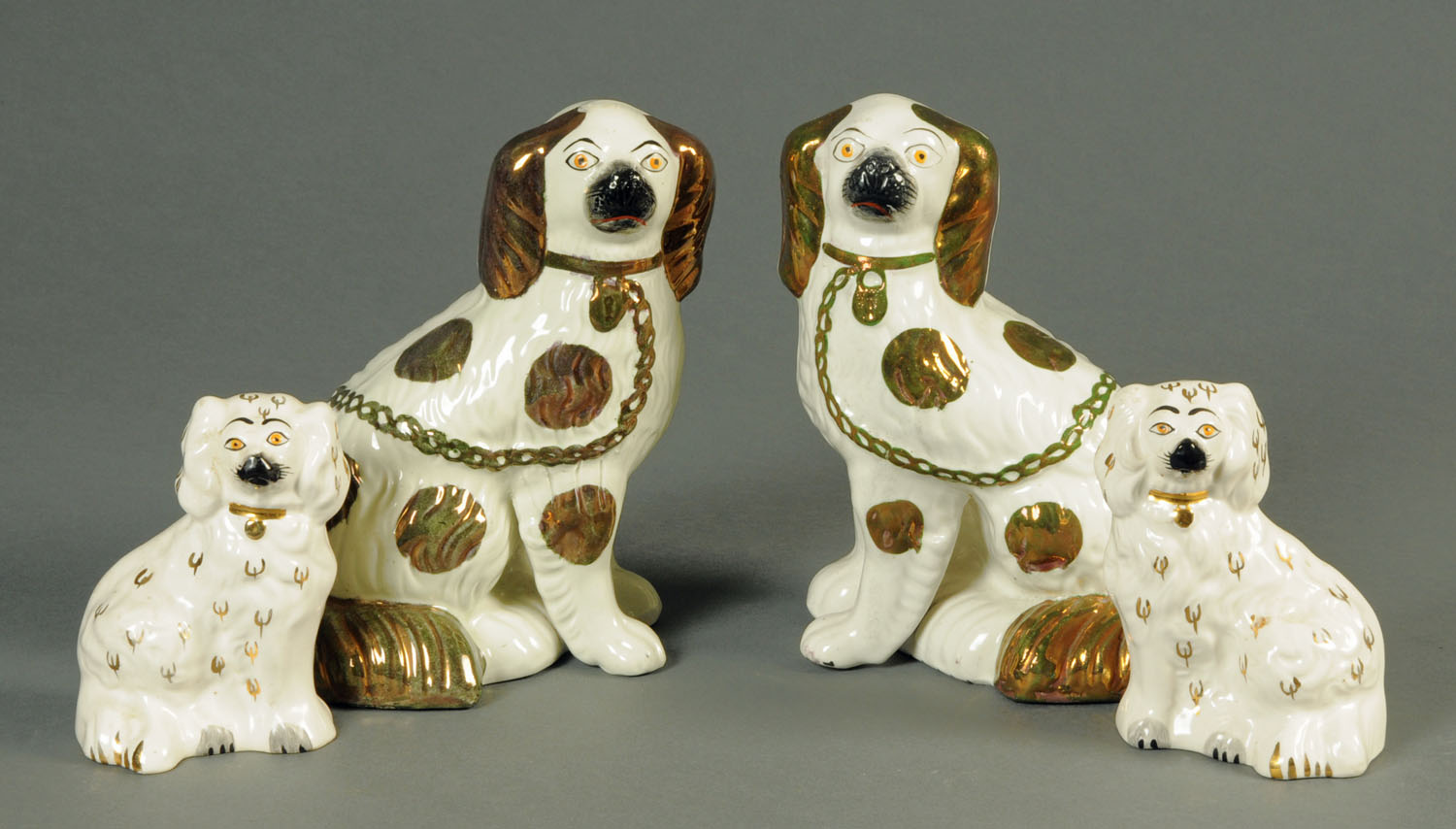 A pair of 19th century Staffordshire dogs, with lustre decoration, height 23 cm, and a smaller pair.