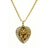 A gold and silver coloured heart shaped locket, with glass back,