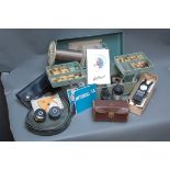 Tackle box containing trout flies, vintage BJ electronic bite alarm and Abu Ambassadeur reel pouch,