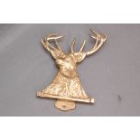 Brass door knocker in the form of a red stag. Length 15 cm.